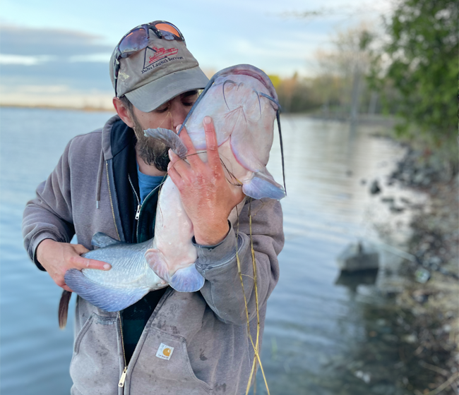 Sean kissing a 20lb channel catfish.
